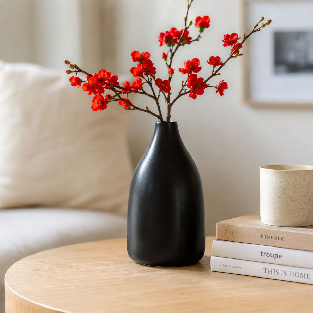 Minimal black ceramic flower vase with red floral arrangement 