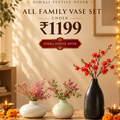 A promotional banner for Morcee Home Decor featuring a Diwali festive offer for an all family vase set. The image showcases three ceramic vases of different shapes and colors (two white, one black) holding pink and red flowers, arranged on a wooden table with candles and marigolds in a warm, decorated home interior.