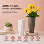 Decorative vases with plants on a pink background, emphasizing artful vessels and refined interior style.