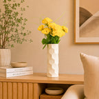 Luxury  honeycomb ceramic flower vase with white flowers styled on a wooden console table in a modern minimalist living room interior.