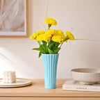 Sky blue ribbed ceramic flower vase with yellow flowers for modern luxury home décor and contemporary interior styling in India