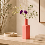 Luxury ceramic bottle-shaped vase with matte finish styled on a beige travertine console table in a modern Scandinavian-inspired interior with olive branches and minimalist décor.