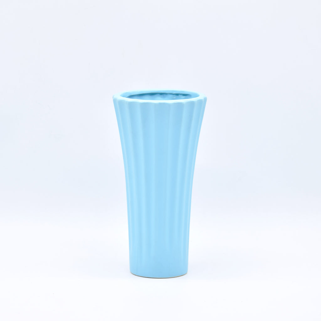 Sky blue ribbed ceramic flower vase with yellow flowers for modern luxury home décor and contemporary interior styling in India