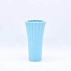 Sky blue ribbed ceramic flower vase with yellow flowers for modern luxury home décor and contemporary interior styling in India
