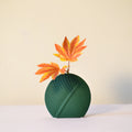 Elegant leaf-shaped ceramic decorative flower vase set with matte finish styled in a modern luxury Indian living room interior with fresh floral arrangement