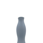 Luxury slim Nordic ceramic flower vase with matte grey finish and orange artificial maple leaves on white table for modern home décor interiors.