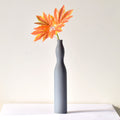 Flute Vase Luxury slim Nordic ceramic flower vase with matte grey finish and orange artificial maple leaves on white table for modern home décor interiors.