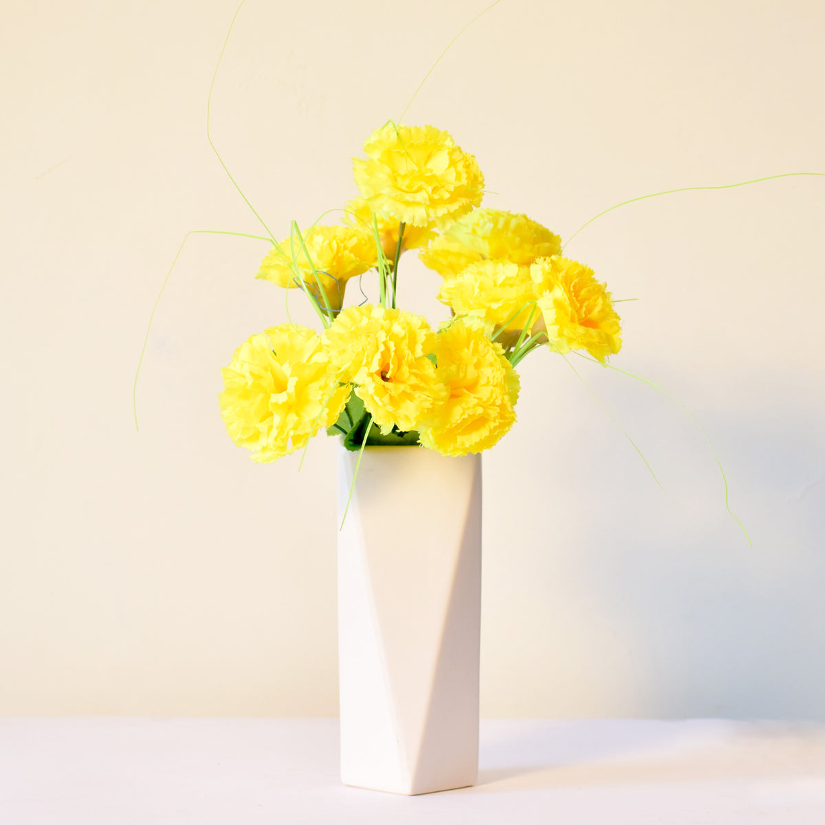 Modern geometric ceramic flower vase with yellow floral arrangement for luxury contemporary Indian home décor