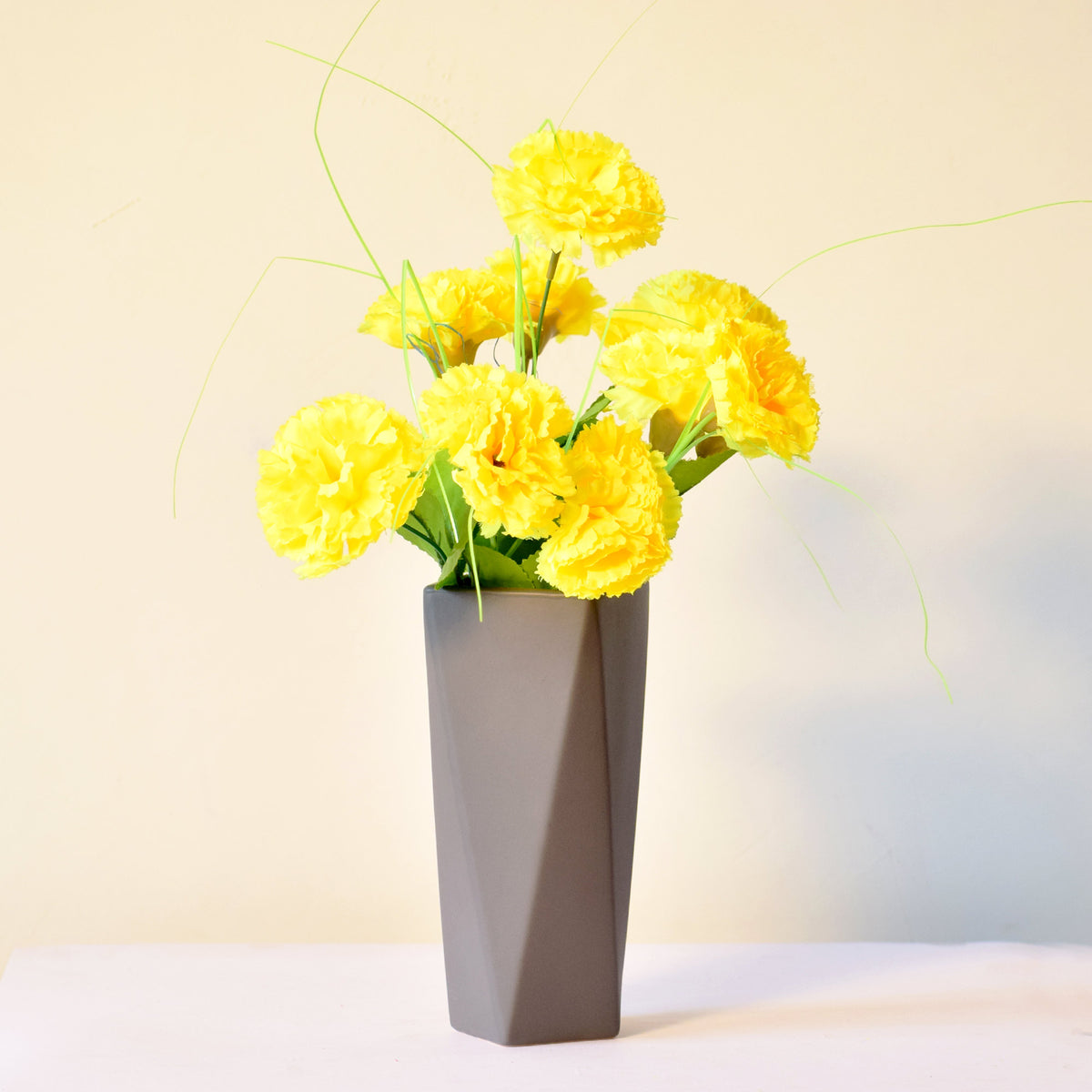 Modern geometric ceramic flower vase with yellow floral arrangement for luxury contemporary Indian home décor
