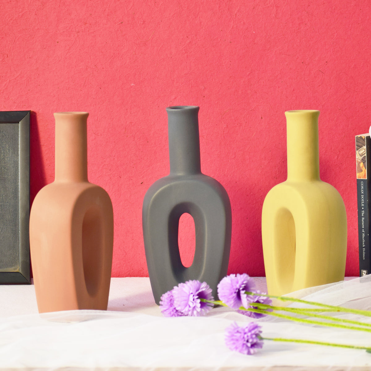 Modern hollow linear ceramic flower vase styled with pampas grass in a minimalist Indian living room interior décor setup