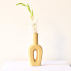 Modern hollow linear ceramic flower vase styled with pampas grass in a minimalist Indian living room interior décor setup