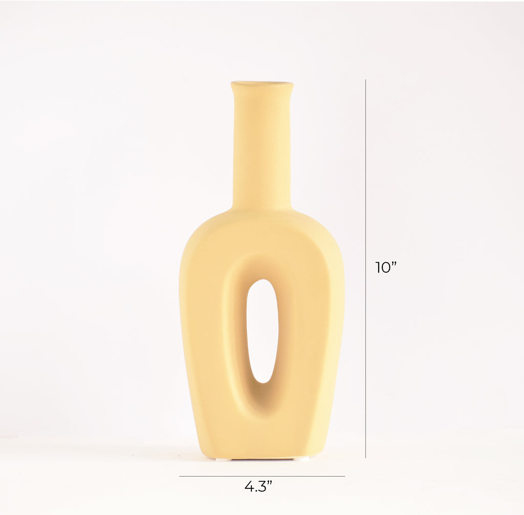 Modern hollow linear ceramic flower vase styled with pampas grass in a minimalist Indian living room interior décor setup