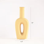Modern hollow linear ceramic flower vase styled with pampas grass in a minimalist Indian living room interior décor setup