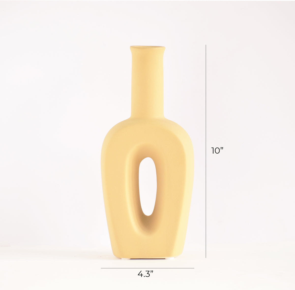 Modern hollow linear ceramic flower vase styled with pampas grass in a minimalist Indian living room interior décor setup