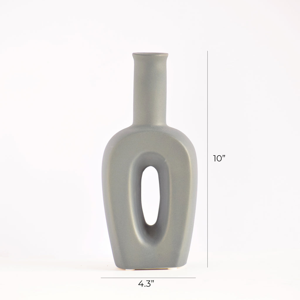 Modern hollow linear ceramic flower vase styled with pampas grass in a minimalist Indian living room interior décor setup