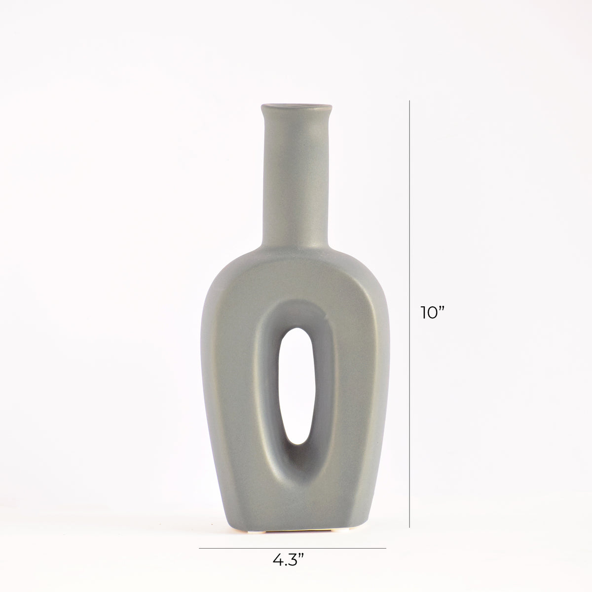 Modern hollow linear ceramic flower vase styled with pampas grass in a minimalist Indian living room interior décor setup