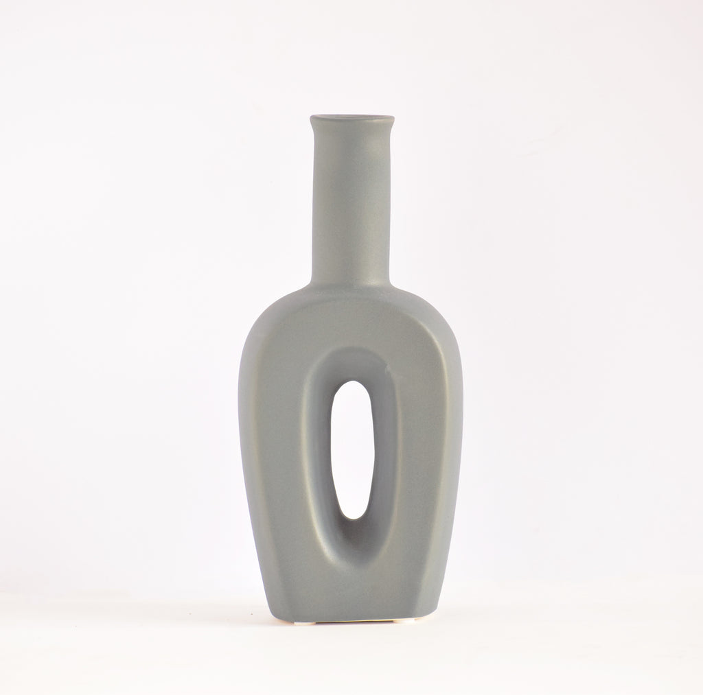 Modern hollow linear ceramic flower vase styled with pampas grass in a minimalist Indian living room interior décor setup
