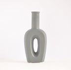 Modern hollow linear ceramic flower vase styled with pampas grass in a minimalist Indian living room interior décor setup