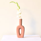 Modern hollow linear ceramic flower vase styled with pampas grass in a minimalist Indian living room interior décor setup