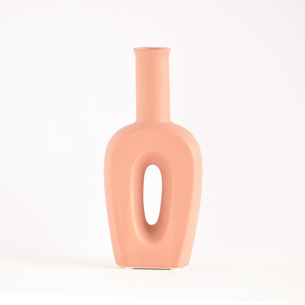 Modern hollow linear ceramic flower vase styled with pampas grass in a minimalist Indian living room interior décor setup