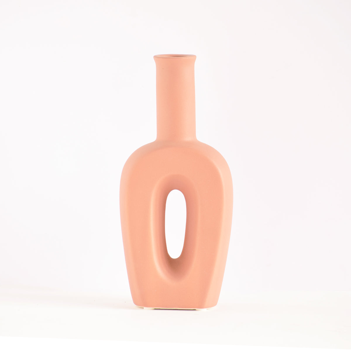 Modern hollow linear ceramic flower vase styled with pampas grass in a minimalist Indian living room interior décor setup