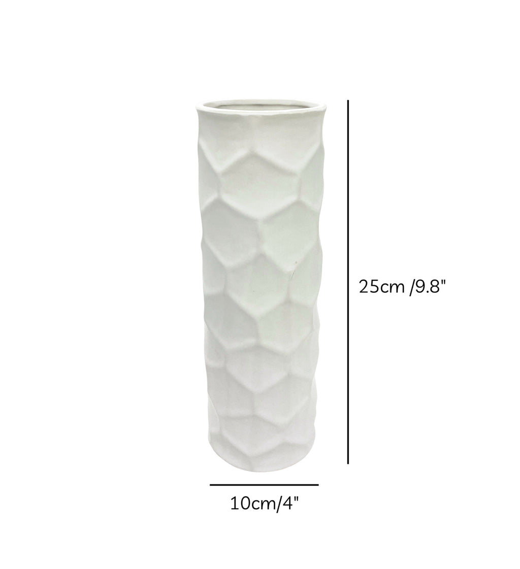 Luxury beige honeycomb ceramic flower vase with white flowers styled on a wooden console table in a modern minimalist living room interior.