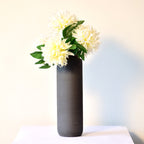 Luxury modern ceramic flower vase styled in a contemporary living room with elegant home décor, minimalist interiors, and premium decorative accents.