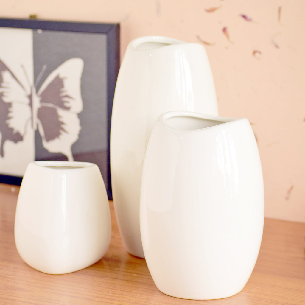 Luxury ceramic vase set with elegant floral styling displayed in a modern contemporary living room with premium home décor accents.