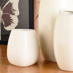 Luxury ceramic vase set with elegant floral styling displayed in a modern contemporary living room with premium home décor accents.