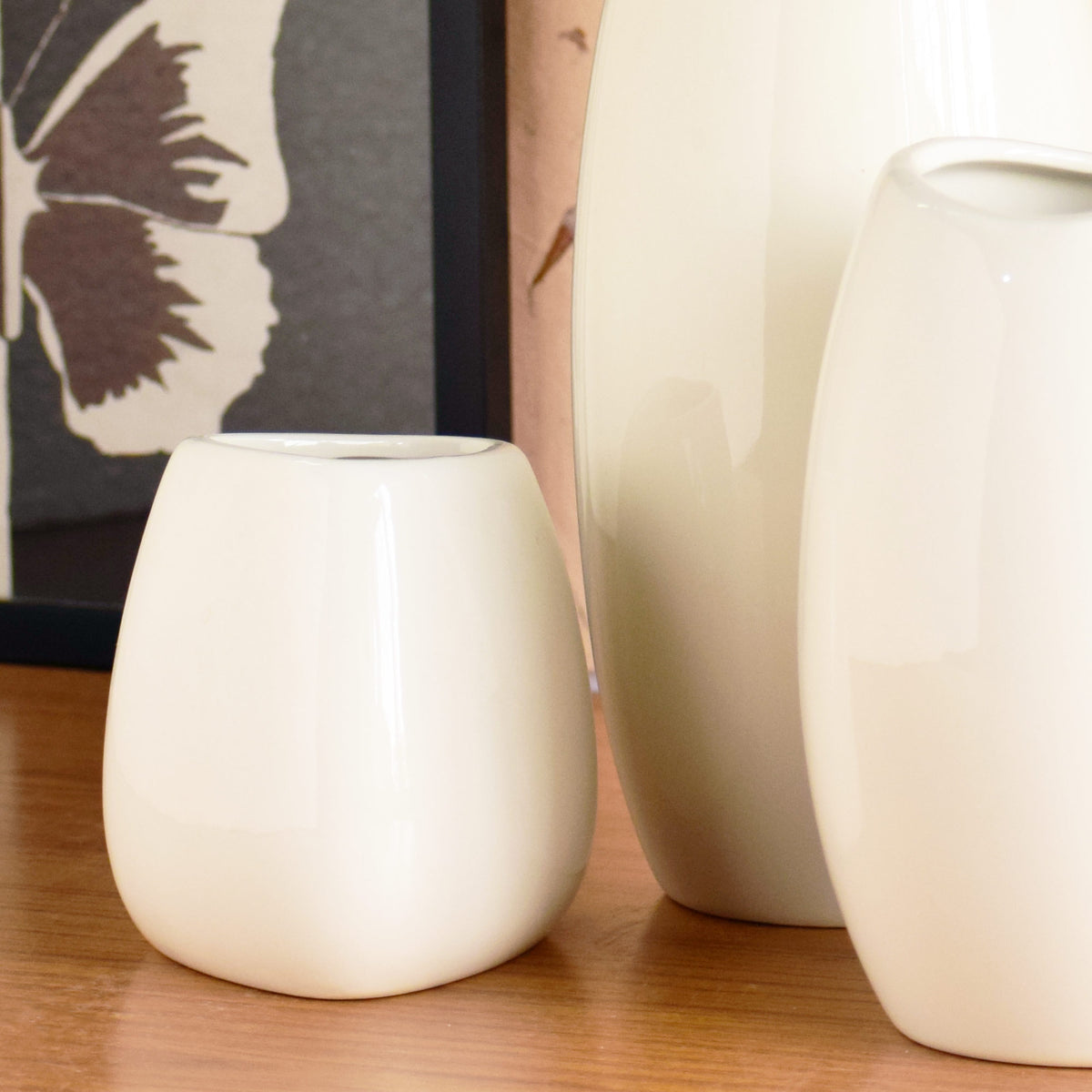 Luxury ceramic vase set with elegant floral styling displayed in a modern contemporary living room with premium home décor accents.