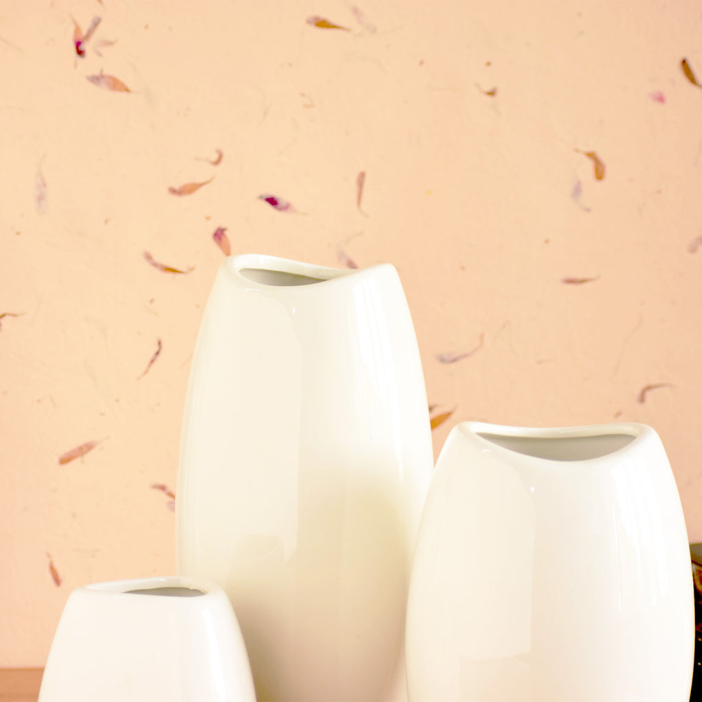 Luxury ceramic vase set with elegant floral styling displayed in a modern contemporary living room with premium home décor accents.