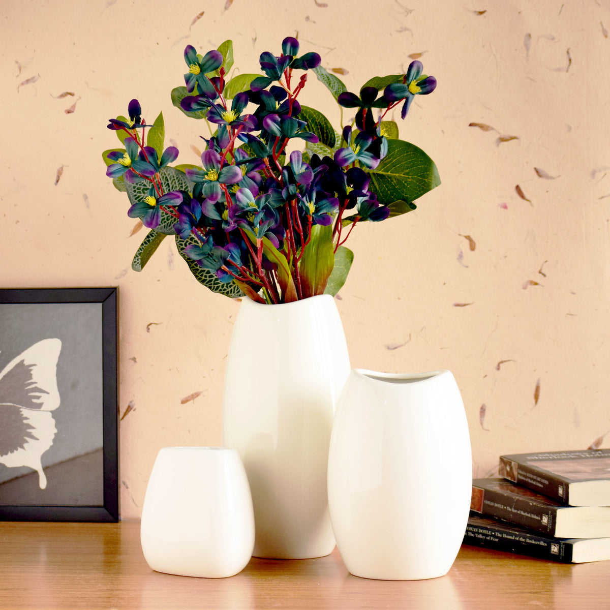 Luxury ceramic vase set with elegant floral styling displayed in a modern contemporary living room with premium home décor accents.