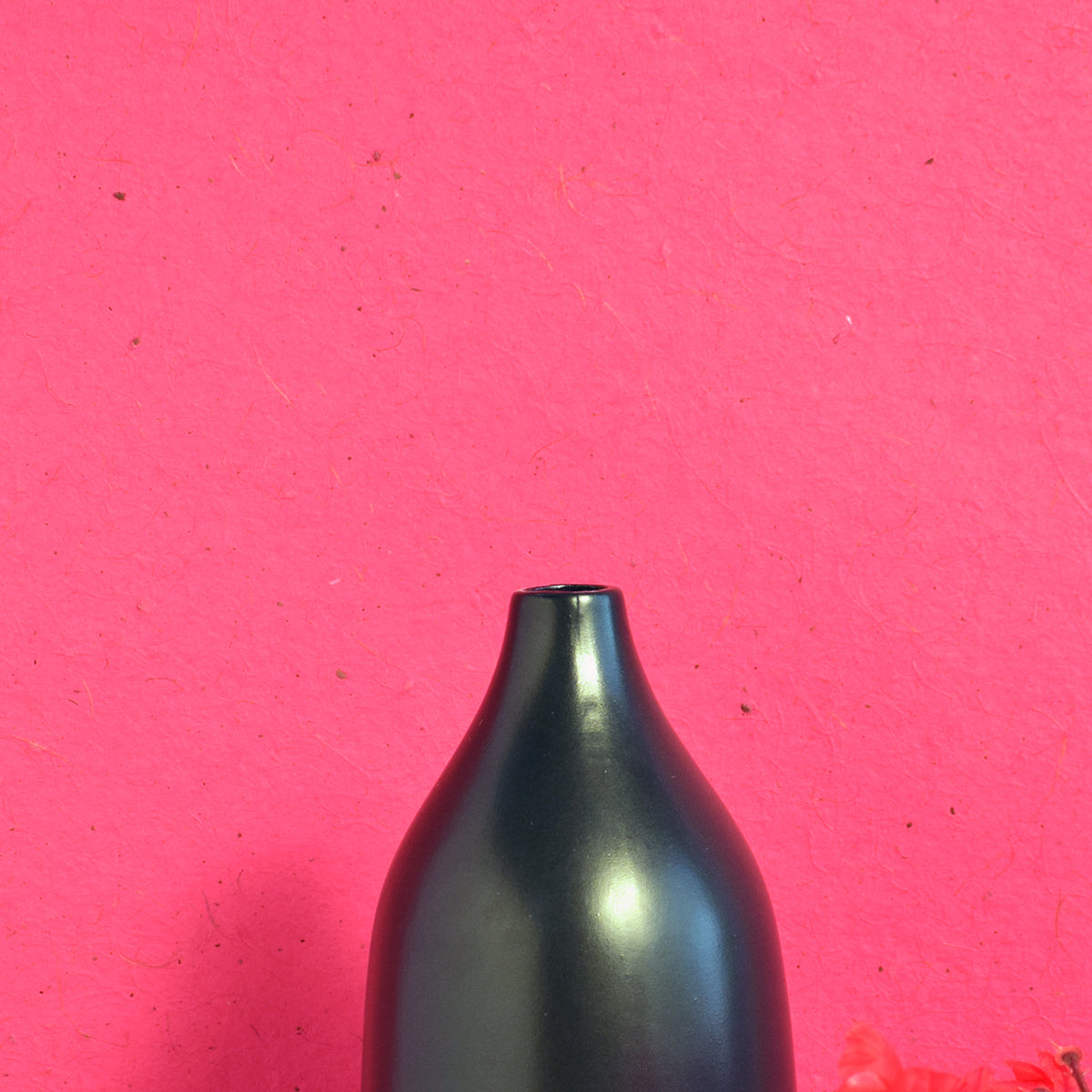 Nordic Linear VaseMinimal black ceramic flower vase with red floral arrangement on boho minimalistic background 