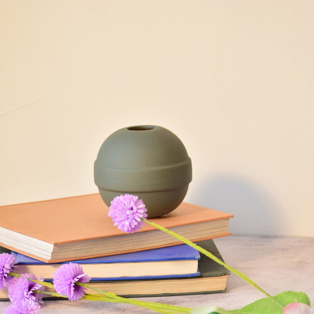 Modern ceramic Pokémon ball vase with baby breath flowers on wooden desk in aesthetic home interior