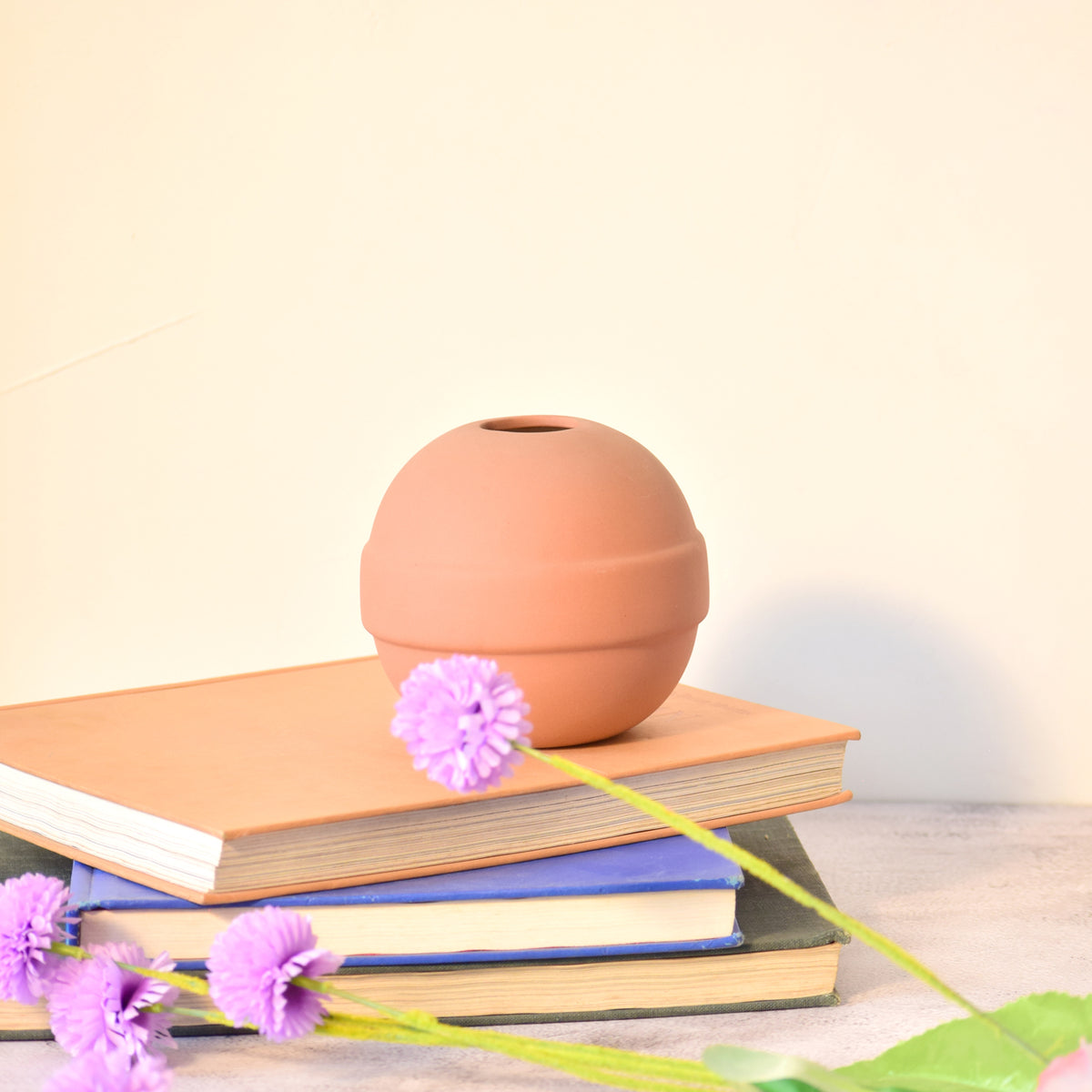 Modern ceramic Pokémon ball vase with baby breath flowers on wooden desk in aesthetic home interior