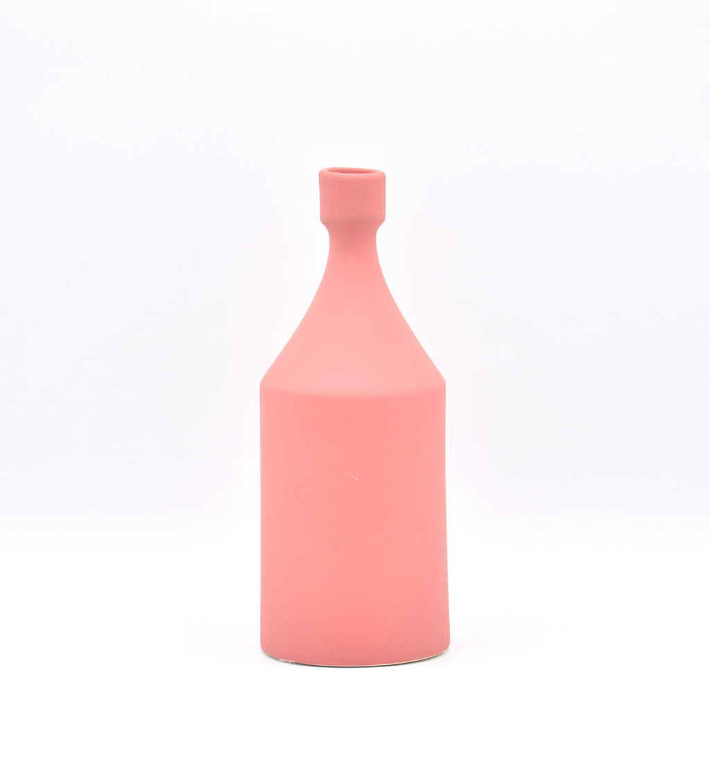 Luxury ceramic bottle-shaped vase with matte finish styled on a beige travertine console table in a modern Scandinavian-inspired interior with olive branches and minimalist décor.