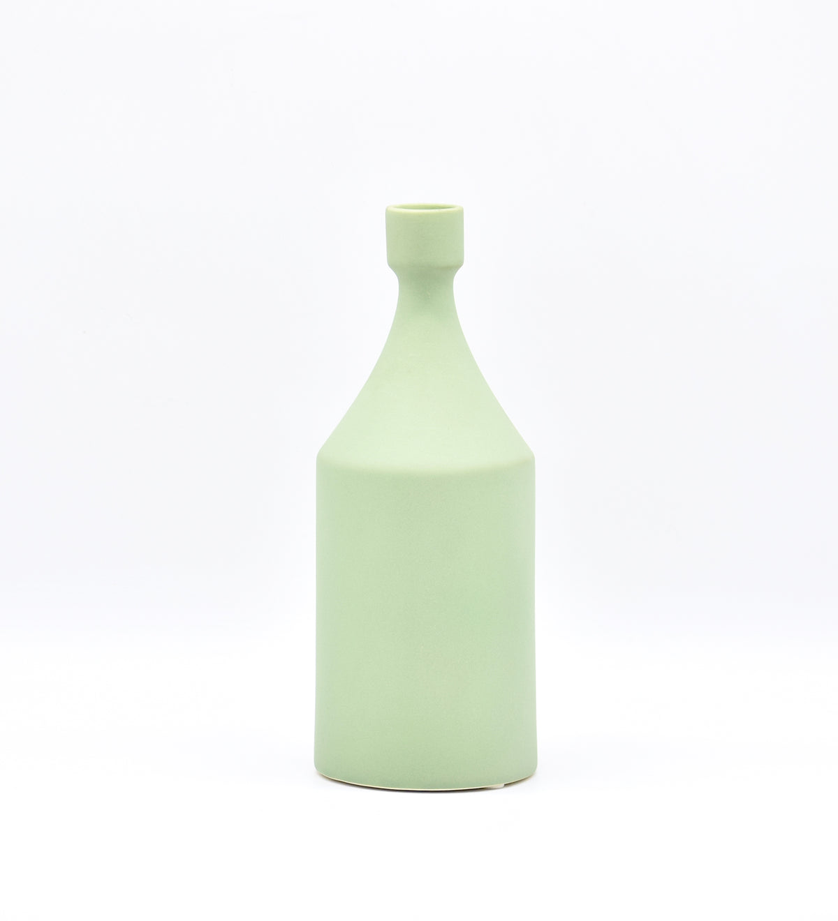 Luxury ceramic bottle-shaped vase with matte finish styled on a beige travertine console table in a modern Scandinavian-inspired interior with olive branches and minimalist décor.