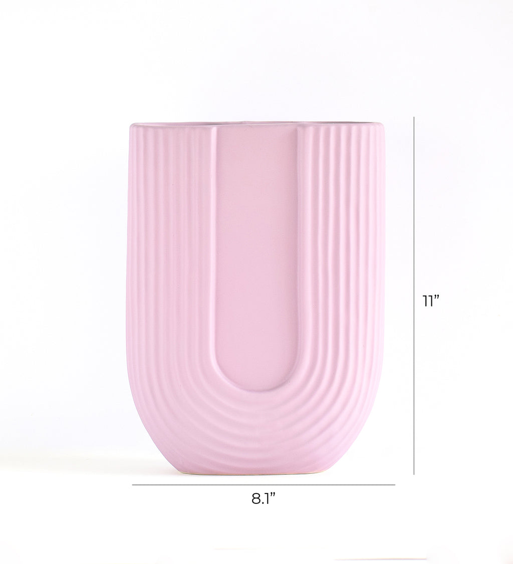 Luxury U-shaped ceramic flower vase with sculptural modern design styled in an elegant contemporary living room interior.