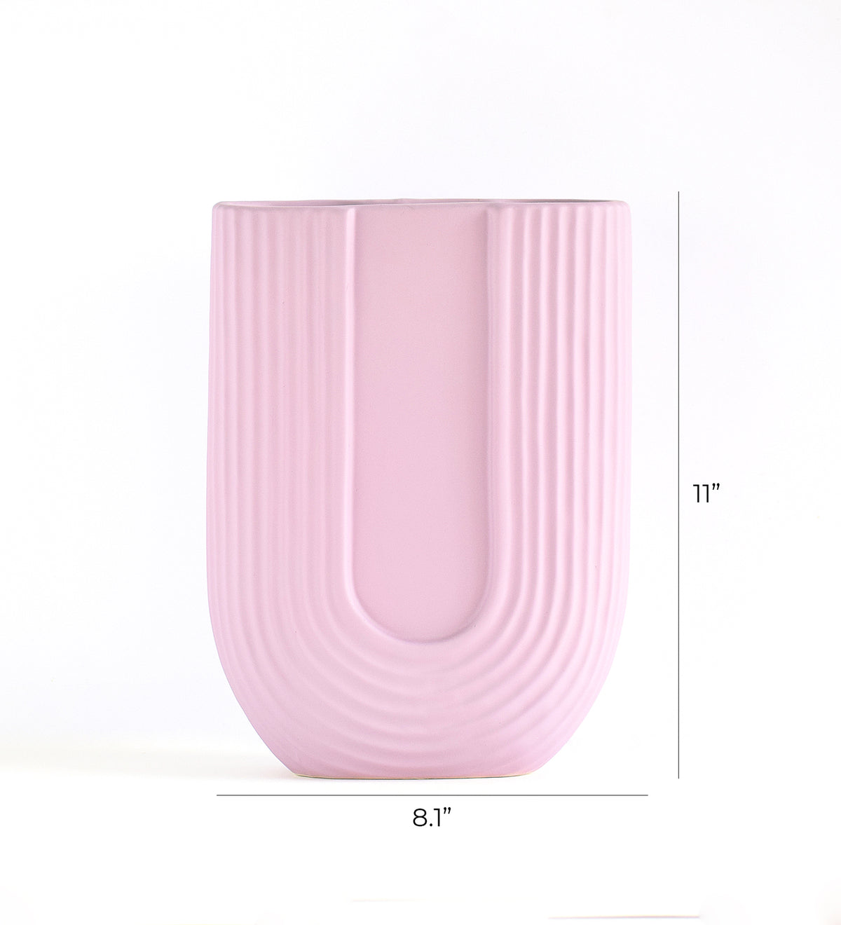 Luxury U-shaped ceramic flower vase with sculptural modern design styled in an elegant contemporary living room interior.