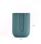 Modern U-shaped ribbed ceramic decorative flower vase styled with dried pampas grass in a luxury minimalist Indian living room interior