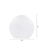 White leaf ceramic flower vase styled with fresh blooms in a modern luxury living room featuring elegant contemporary décor.
