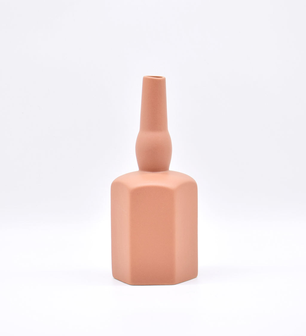 Luxury ceramic bottle-shaped vase with matte finish styled on a beige travertine console table in a modern Scandinavian-inspired interior with olive branches and minimalist décor.