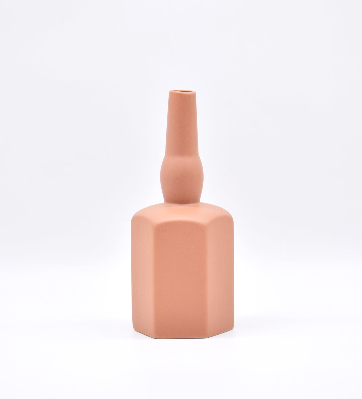 Luxury ceramic bottle-shaped vase with matte finish styled on a beige travertine console table in a modern Scandinavian-inspired interior with olive branches and minimalist décor.
