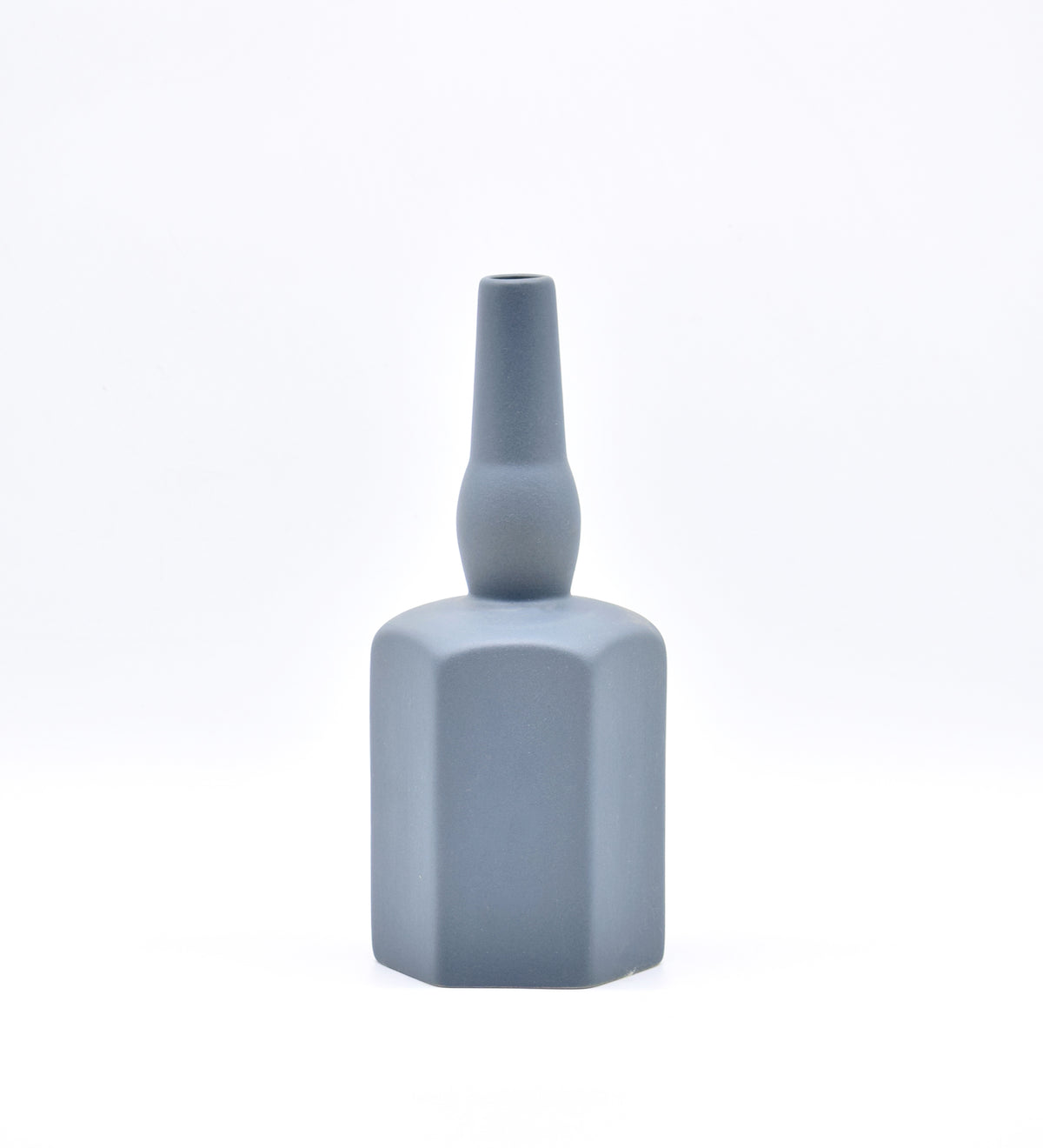 Luxury ceramic bottle-shaped vase with matte finish styled on a beige travertine console table in a modern Scandinavian-inspired interior with olive branches and minimalist décor.