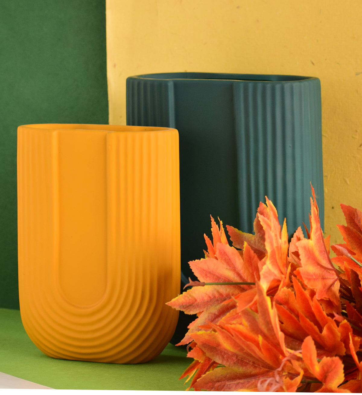 Luxury U-shaped ceramic flower vase with sculptural modern design styled in an elegant contemporary living room interior.